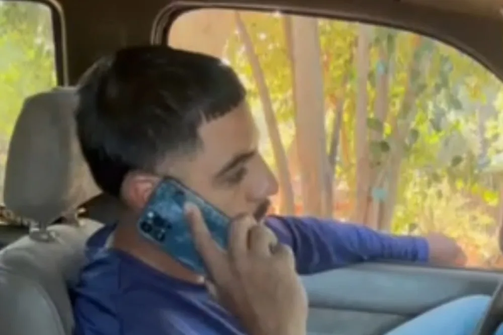 Odon Molina taking a customer call in his truck