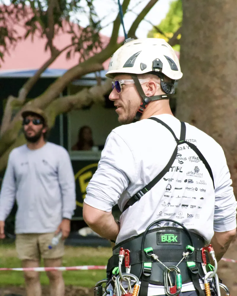 Oliver Moore in his climbing harness at a tree climbing competition
