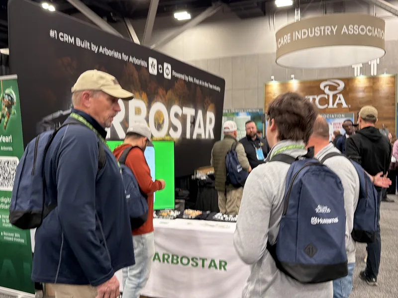 Visitors at the ArboStar booth at TCI EXPO 2025, beside the TCIA stand